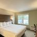 Baymont by Wyndham Lake Park Valdosta I75 guest room with king bed, desk and window