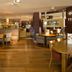 Premier Inn Ashford - Eureka Leisure Park restaurant with wooden tables, chairs and warm lighting in Ashford