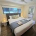 Noosa River Retreat in Noosa Heads bedroom with queen bed, window view, and mirrored wardrobe