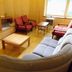 Cafe & Inn That Sounds Good in Semboku guest room with sofa, chairs, table, and window