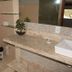 Pousada Innova, Natal: bathroom with toilet, stone vanity, vessel sink, shelves, and potted plant