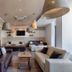 AX Sunny Coast Resort & Spa lobby lounge with sofas, coffee table, and pendant lights in Saint Paul’s Bay