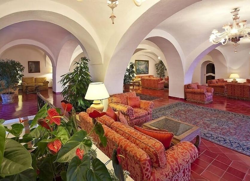 Grand Hotel Il Moresco in Ischia lounge with arched ceilings, patterned sofas, chandeliers and red tile floor