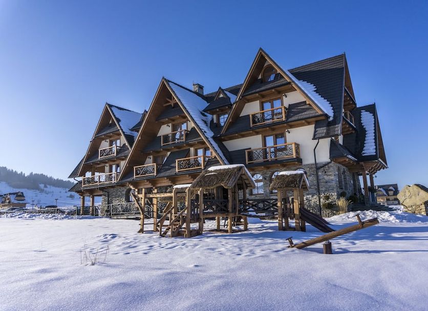Silverton in Białka Tatrzańska, snowy alpine-style hotel exterior under a clear blue sky