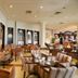 Charmillion Club Resort in Sharm el-Sheikh restaurant with tables, chairs, arches and a bar area
