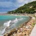 Hotel Del Golfo in Finale Ligure overlooking a turquoise bay, rocky shoreline, and hillside coast