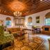 Moller Villa Hotel Shanghai suite with ornate wood ceiling, chandelier, and classic seating in Shanghai