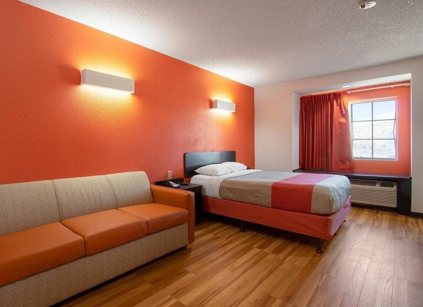 Motel 6 El Paso - Southeast guest room with bed, sofa, orange accent wall and window