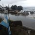 Hosteria Las Amapolas in San Carlos de Bariloche with lake view, roadside parking, and rainy street