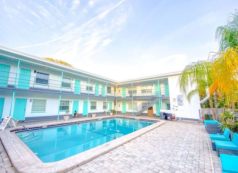 Uptown Inn & Suites in St. Petersburg courtyard pool with two-story exterior and lounge chairs