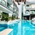 Chalay Monta in Hua Hin with a pool, slide, and modern hotel buildings