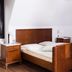 Palac Krobielowice guest room in Kąty Wrocławskie with wooden bed, bedside tables and sloped ceiling.