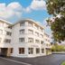 Bhoma Bourges - Hôtel in Bourges, modern white hotel exterior with arched facade and driveway