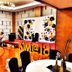 Starlodge Jerudong event hall with balloon-decorated stage, projector screen, and polished wood floor
