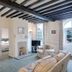 The Grove Cromer in Cromer: airy suite with beamed ceiling, fireplace, armchairs, and garden-facing windows