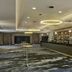 DoubleTree by Hilton Hull lobby bar with long counter, shelves of bottles and ballroom entrance
