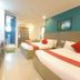 Legazpi Tourist Inn in Legazpi City offers a twin room with two beds, wall-mounted TV, and bright modern decor.