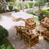 Sarges Hotel Serrekunda outdoor patio seating area with bamboo chairs and sofas surrounded by greenery