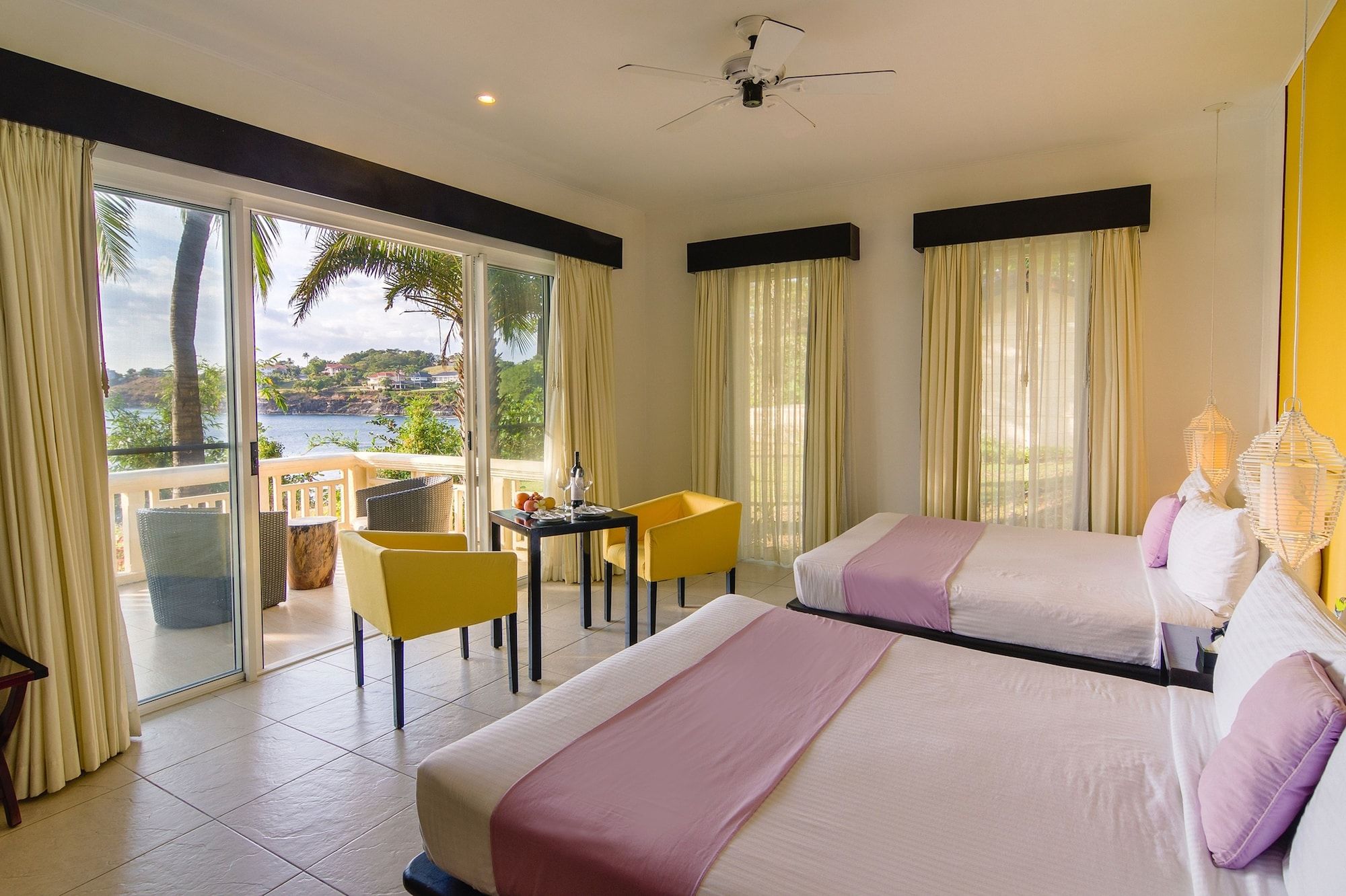 Club Punta Fuego in Nasugbu guest room with twin beds, balcony doors, and lagoon views