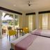 Club Punta Fuego in Nasugbu guest room with twin beds, balcony doors, and lagoon views