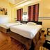 Hotel Sibayak International Berastagi room with two twin beds and wood floors