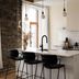 Maison Place Royale by Luxury In Transit Montreal kitchen with island, bar stools and stainless steel fridge