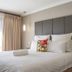 Ruslamere Hotel and Conference Centre in Durbanville: bright hotel room with king bed, bedside table and curtains