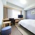 Richmond Hotel Naha Kumoji guest room with bed, desk, TV and window seating in Naha