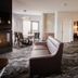 Prairie Band Casino & Resort in Mayetta living area with fireplace, dining table and kitchen bar seating