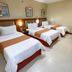 Royal Garden Hotel in Ozamiz: triple room with three single beds and wall art