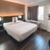 Motel 6 Sacramento West guest room with queen bed, window, desk and chair in Sacramento