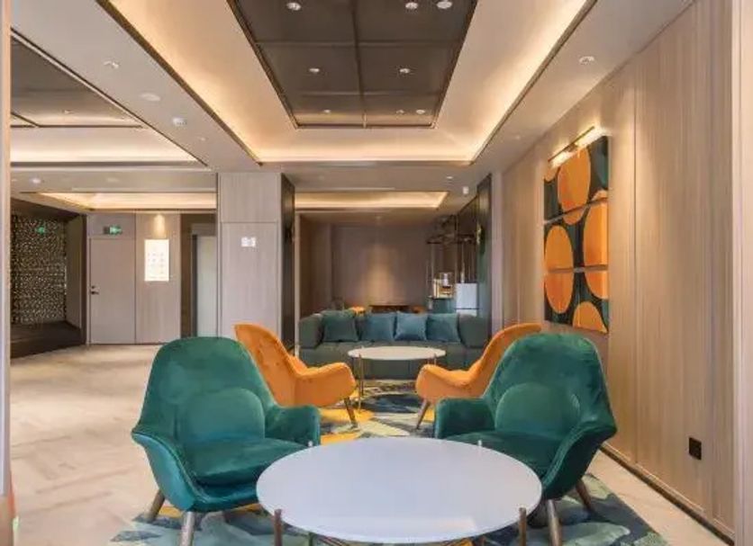 Orange Hotel Beijing Japan Medical University lobby seating area with teal and orange lounge chairs in Beijing