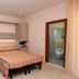Hotel Concorde Cesenatico room with double bed, blue sofa and open bathroom door