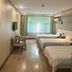 Dream 8 Business Hotel in Taizhou guest room with three single beds and window curtains