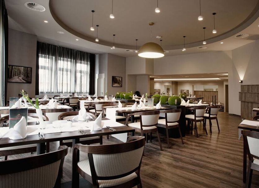 Ferien Appartements Am Berghotel Oberhof restaurant dining room in Oberhof with set tables and modern lighting