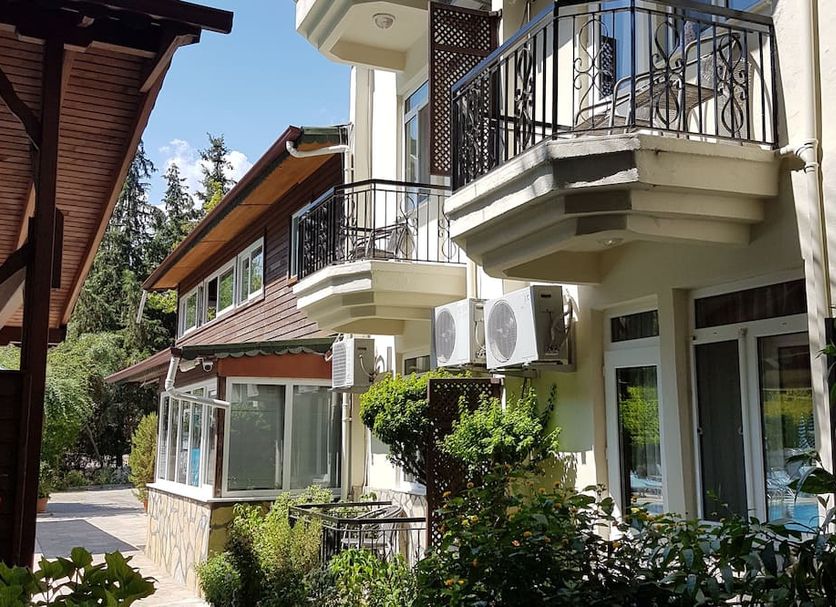 Canada Hotel & Bungalows in Cirali, exterior with balconies, air conditioners, and landscaped greenery