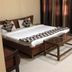 Goroomgo Mourya Inn Madhya Pradesh guest room in Harda with double bed, curtains and bedside tables