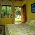 Arte Natura Boutique Hotel in La Fortuna room with bed, garden view, and open door to patio