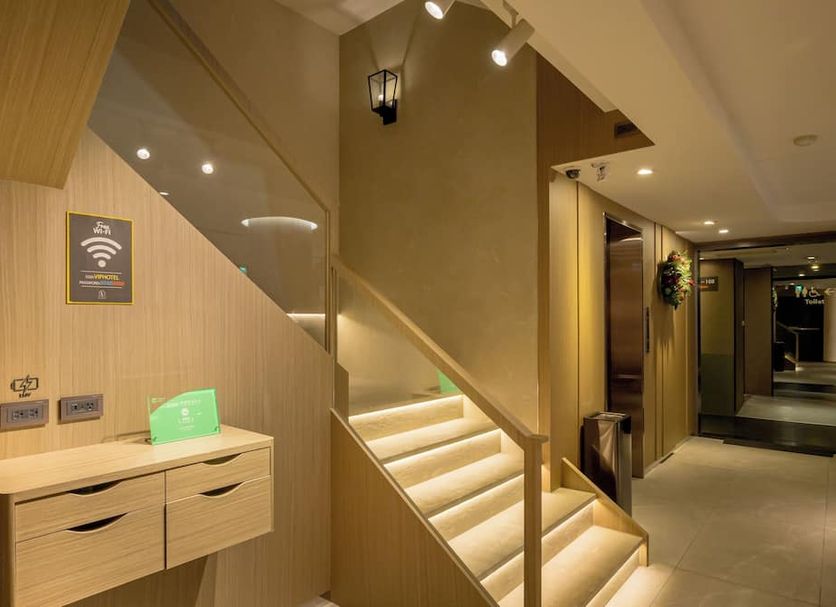 Vip Hotel Taipei City lobby stairway with glass railing, wood-paneled walls and a lit corridor