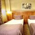 Adana Garden Business Hotel, Adana: twin beds in a guest room with wood headboard and wall art