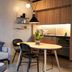 Hotel Guestapart Aarhus apartment-style room with sofa, dining table, kitchenette and pendant lighting