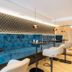 Heilthermen Resort Bad Waltersdorf lounge with blue velvet seating and small round tables in Bad Waltersdorf