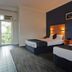 Sanctuary Resort Motor Inn in Coffs Harbour twin hotel room with two beds and blue feature wall