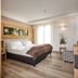 Family Hotel Serena in Andalo, bright guest room with bed, wood accents, TV and window