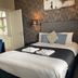 The White Swan Leeds guest room with double bed, geometric wallpaper and bedside lamps