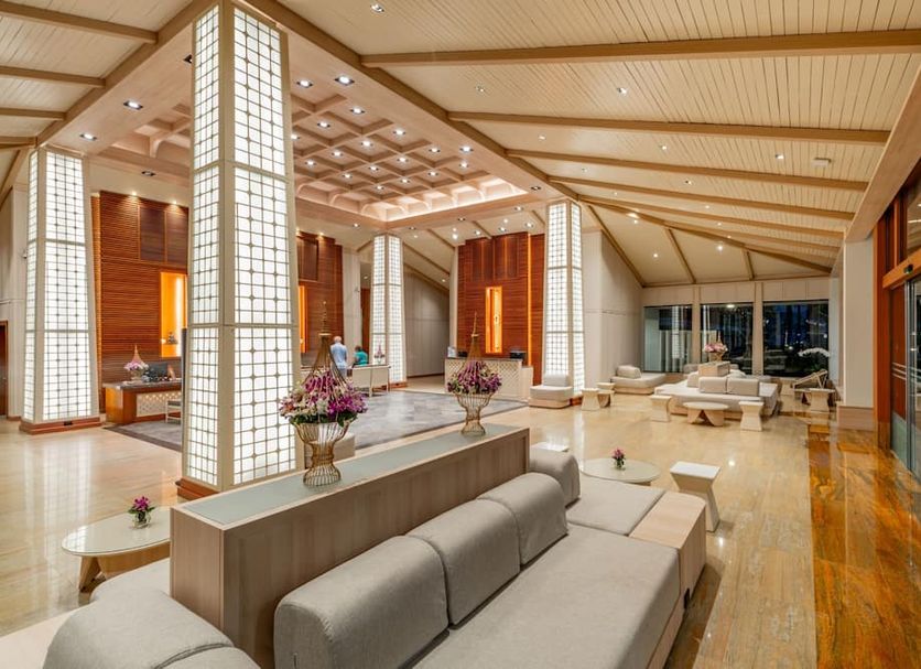 Katathani Phuket Beach Resort lobby in Karon with lounge seating, high ceilings and warm wood accents