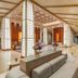 Katathani Phuket Beach Resort lobby in Karon with lounge seating, high ceilings and warm wood accents