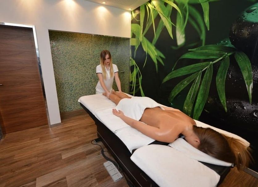 Hotel Hercegovina Sarajevo spa treatment room with two guests on massage tables and tropical wall mural