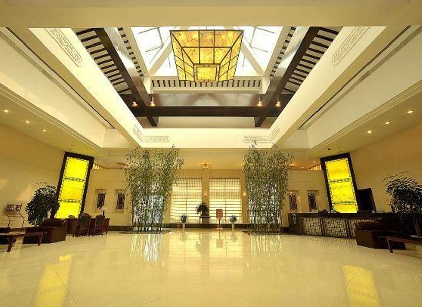 Taizhou Chunlan Hotel lobby in Taizhou with skylight, polished floor and tall indoor plants