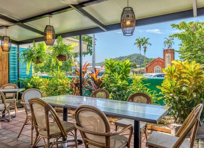 Demi View Motel Mossman outdoor dining area with tropical garden and mountain view